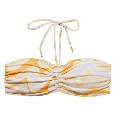 Packshot of Brigitte Bikini Bandeau in creme, orange and purple tones in a wavy pattern with Underprotection and Blanche logo in between.